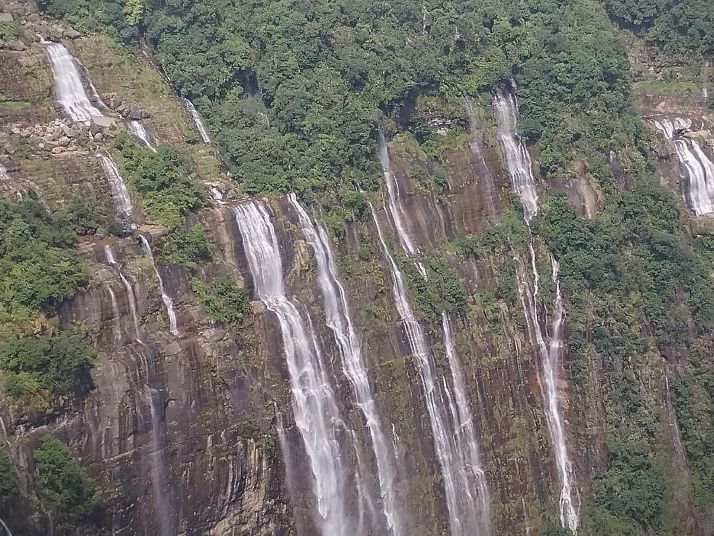 Monsoon streams braided down the Seven Sisters cliff face near Mawsmai